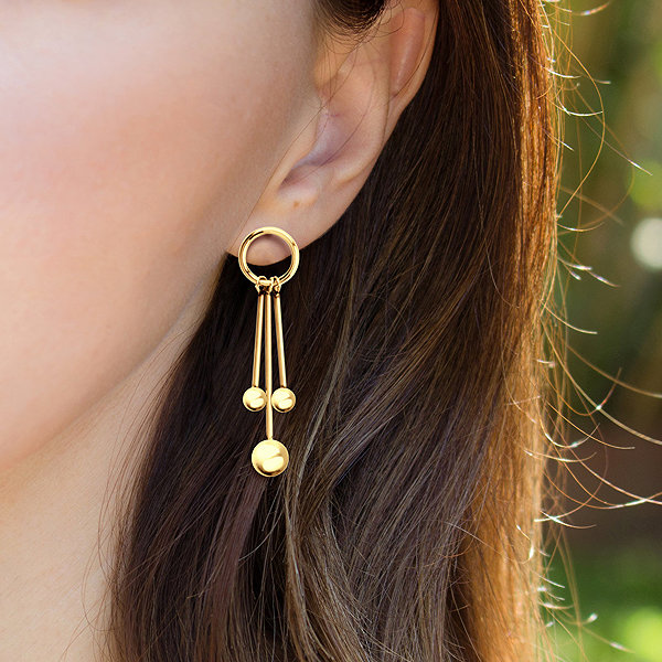 Bruno BALLS gold drop earrings.