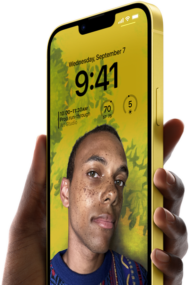 Ruka držící žlutý iPhone 14 Plus se zobrazenou personalizovanou zamknutou obrazovkou.