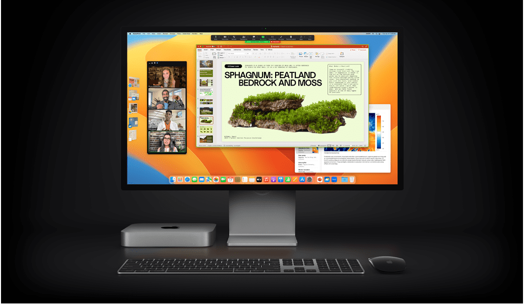 Mac mini s Magic Mouse, Magic Keyboardom a Studio Displayom, na ktorom sa zobrazuje prezentácia v Microsoft PowerPointe zdieľaná v schôdzke na Zoome s aplikáciou Poznámky na pozadí.